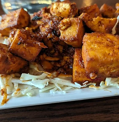 Spicy fried paneer cubes on shredded cabbage at Bawarchi in Mississauga