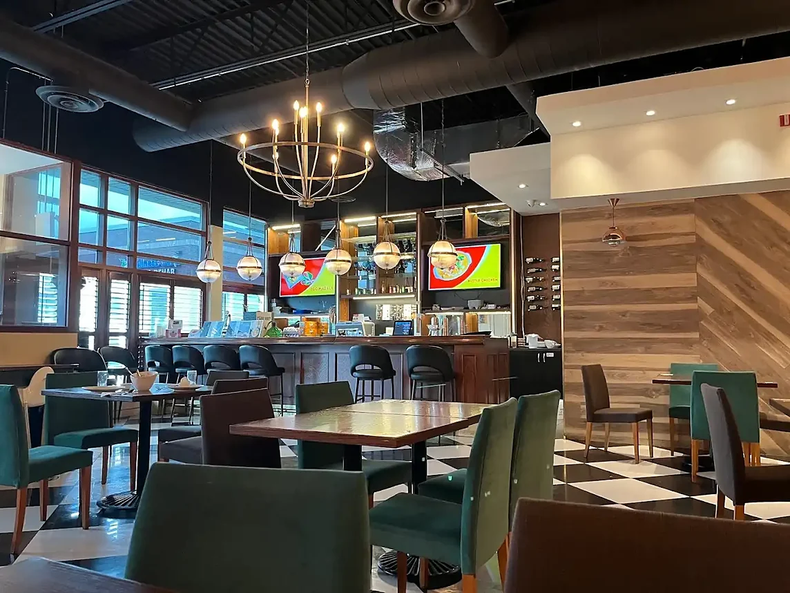 Dining room with booths, tables and a checkered floor at Bawarchi in Mississauga